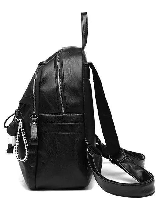 Black soft-surface leather backpack with 24-litre capacity showing ID pocket and luggage strap attachments