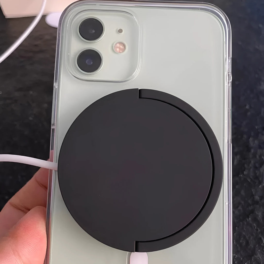 Black magnetic wireless charging bracket holding a mobile phone at an angle
