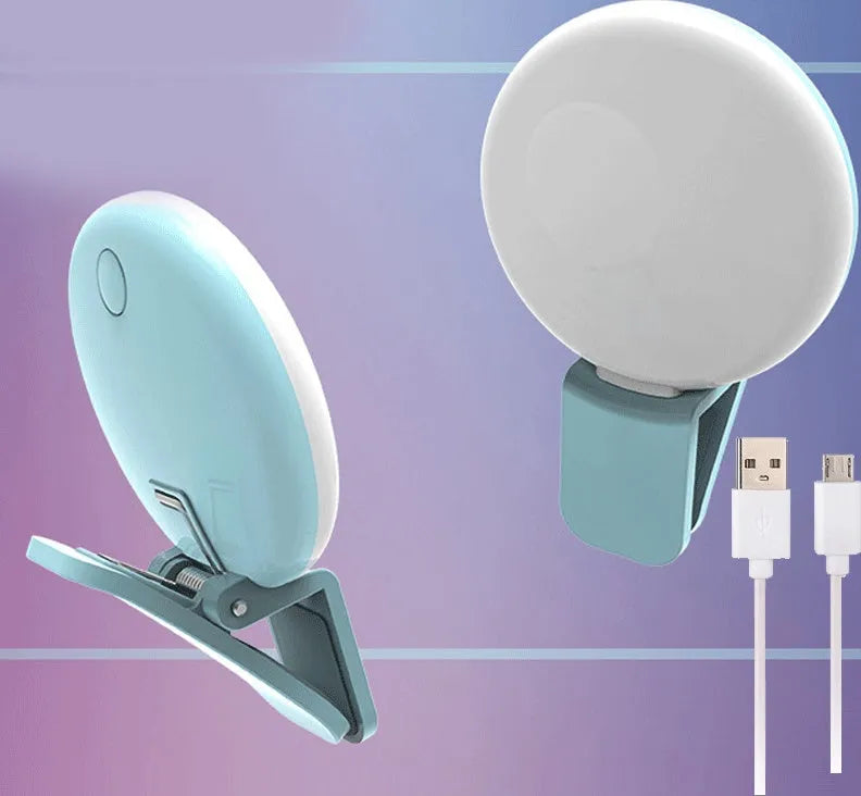 Small round white LED fill light clipped to the top of a mobile phone.