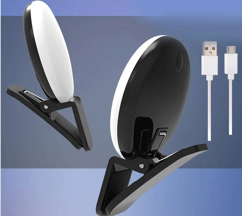 Small round white LED fill light clipped to the top of a mobile phone.