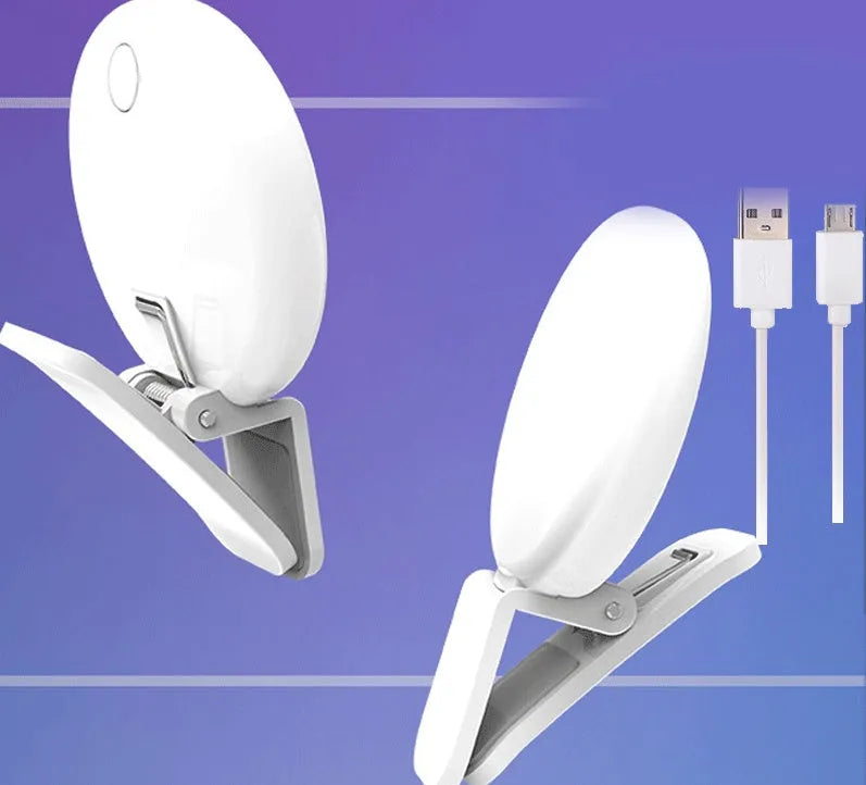 Small round white LED fill light clipped to the top of a mobile phone.
