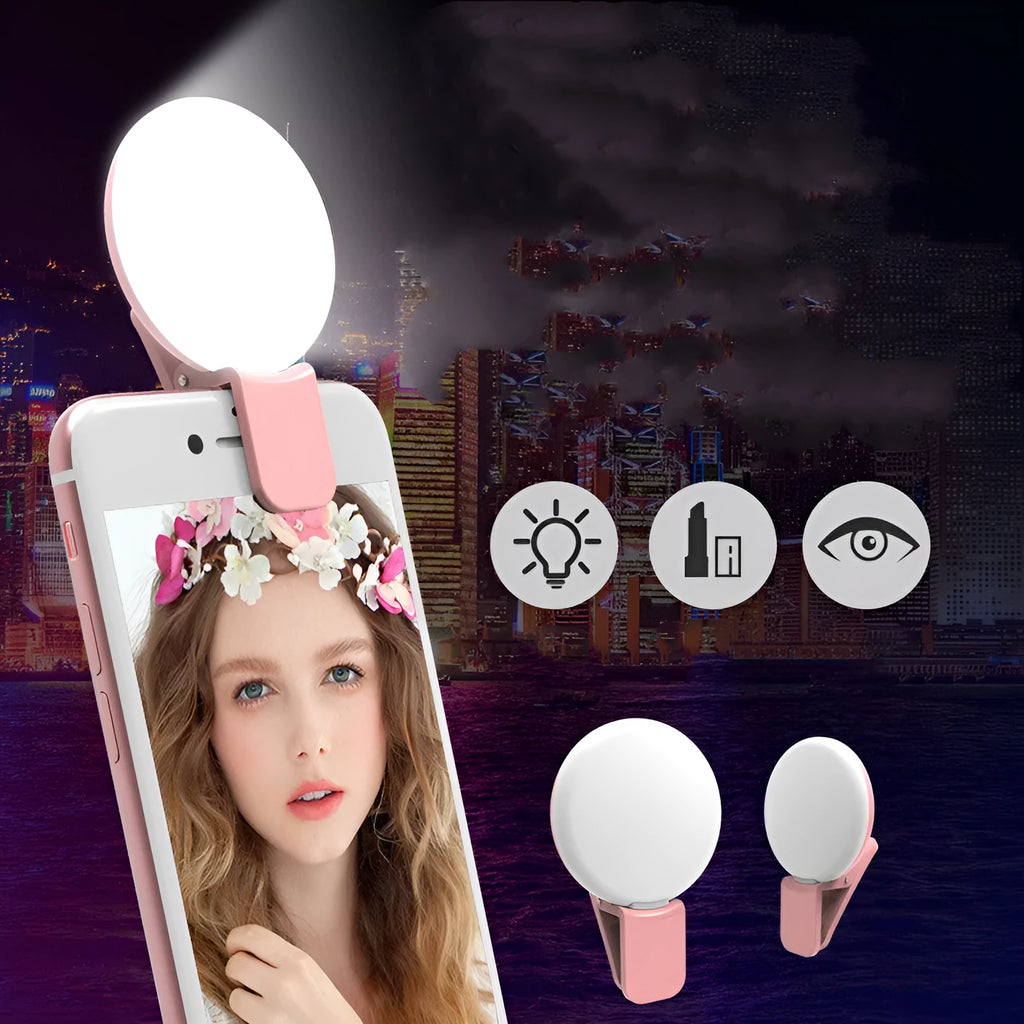 Small round white LED fill light clipped to the top of a mobile phone.