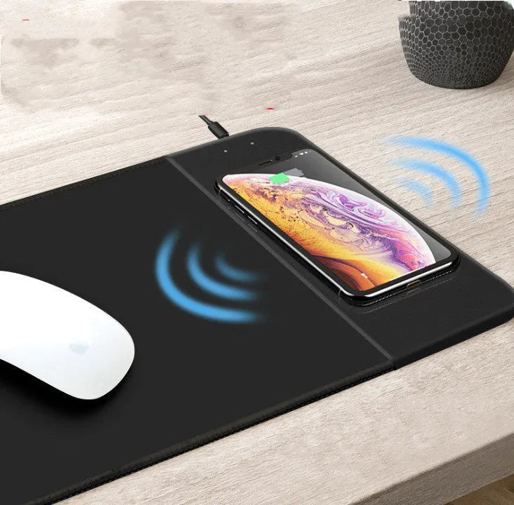 Cartoon design wireless charging mouse pad with RGB lighting on a desk