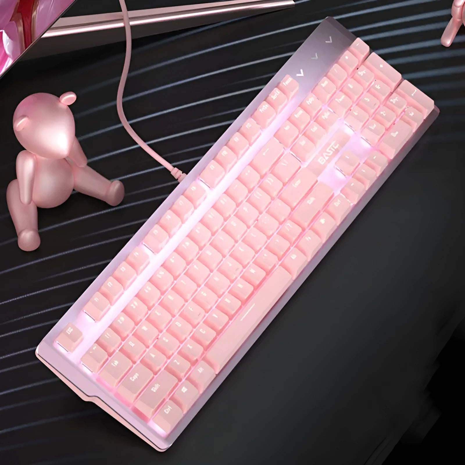 Pink mechanical keyboard and wired gaming mouse set on a desk.