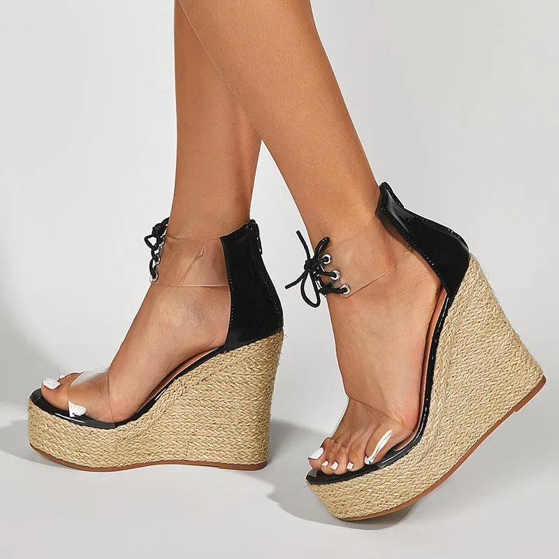 Black women's wedge sandals with hemp rope on wedge, front tie closure, and high platform sole.