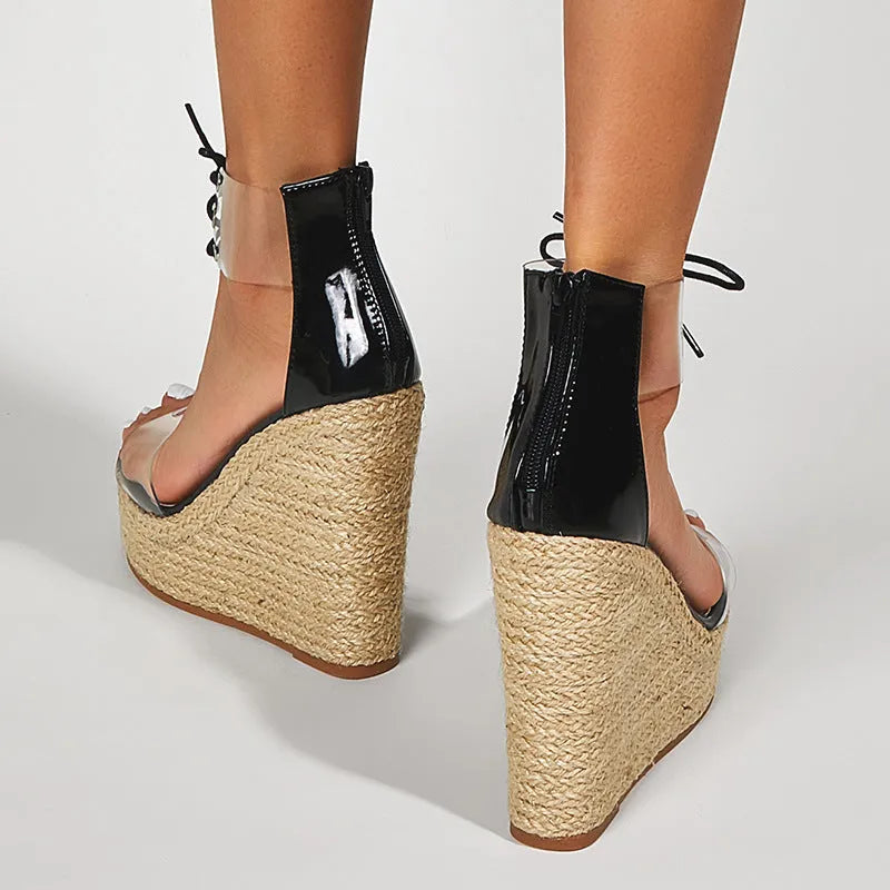 Black women's wedge sandals with hemp rope on wedge, front tie closure, and high platform sole.
