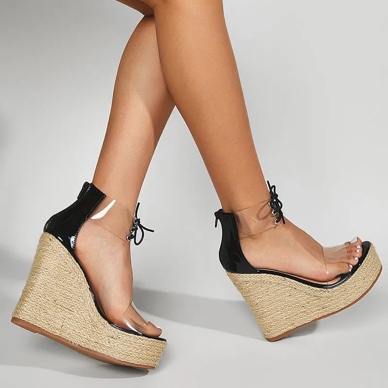 Black women's wedge sandals with hemp rope on wedge, front tie closure, and high platform sole.