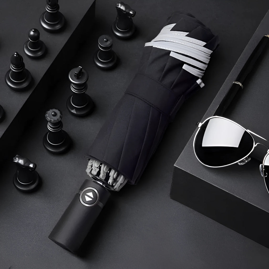 Automatic reverse folding umbrella with black canopy, plastic handle, shown open and closed.