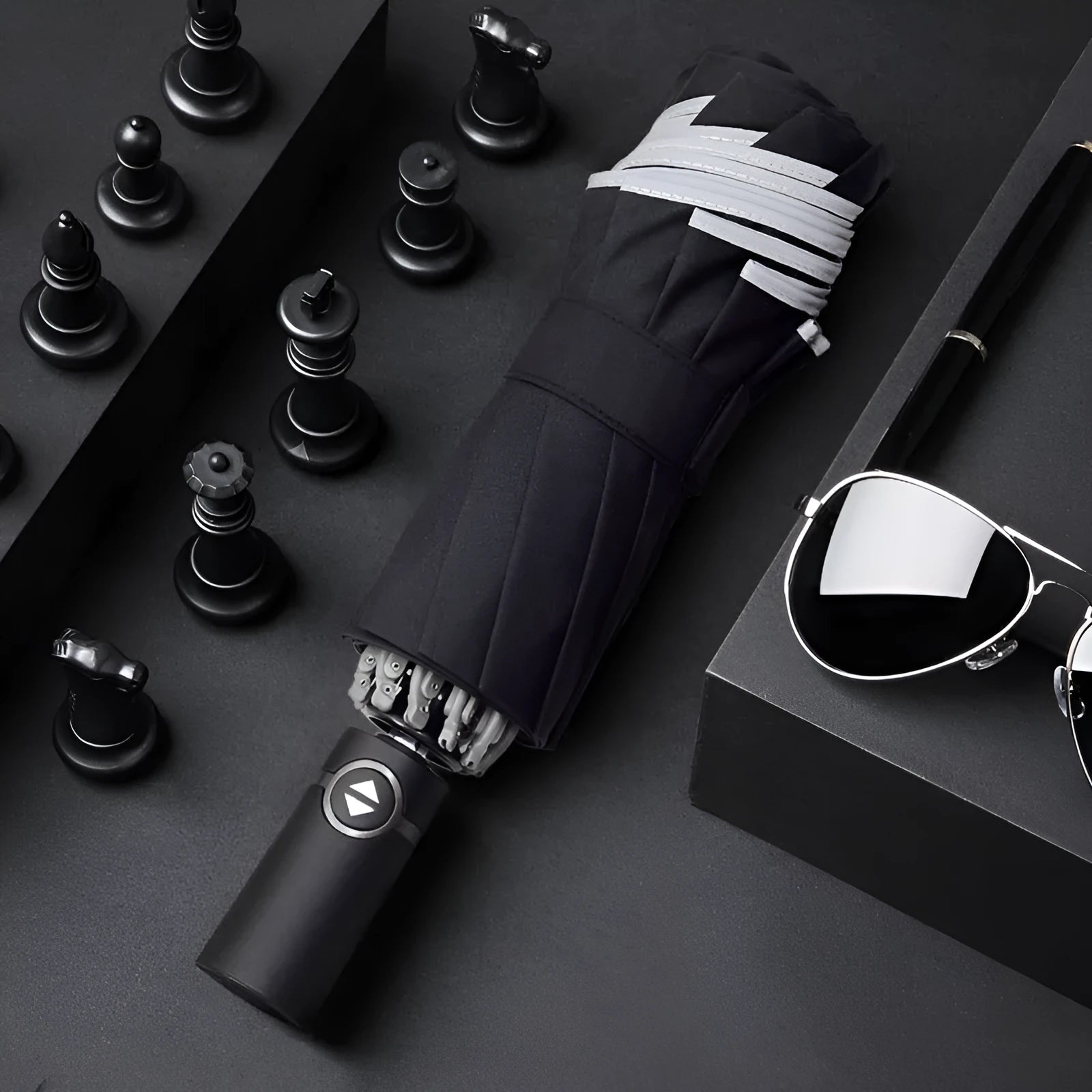 Automatic reverse folding umbrella with black canopy, plastic handle, shown open and closed.