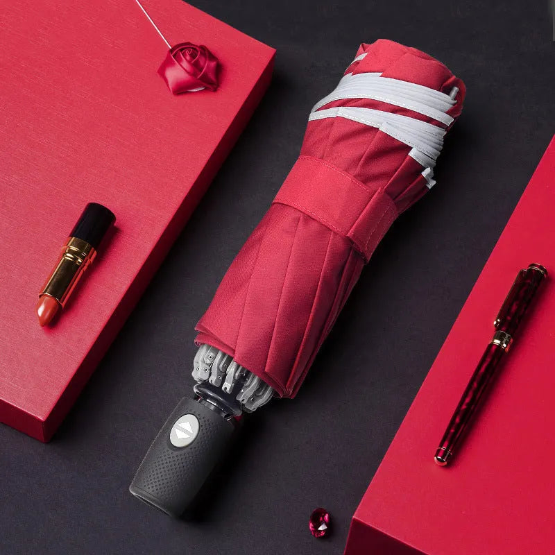 Automatic reverse folding umbrella with black canopy, plastic handle, shown open and closed.