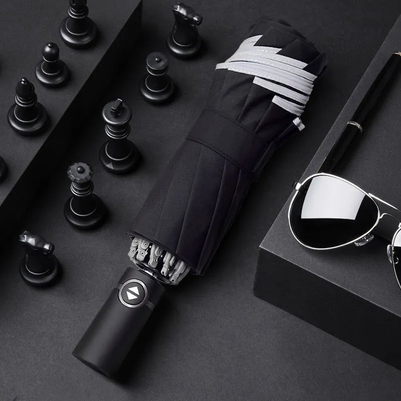 Automatic reverse folding umbrella with black canopy, plastic handle, shown open and closed.
