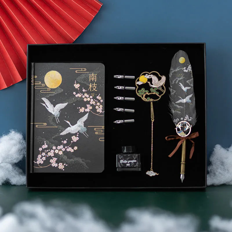 Chinese feather pen set with 36 quills in metal case and notebook.