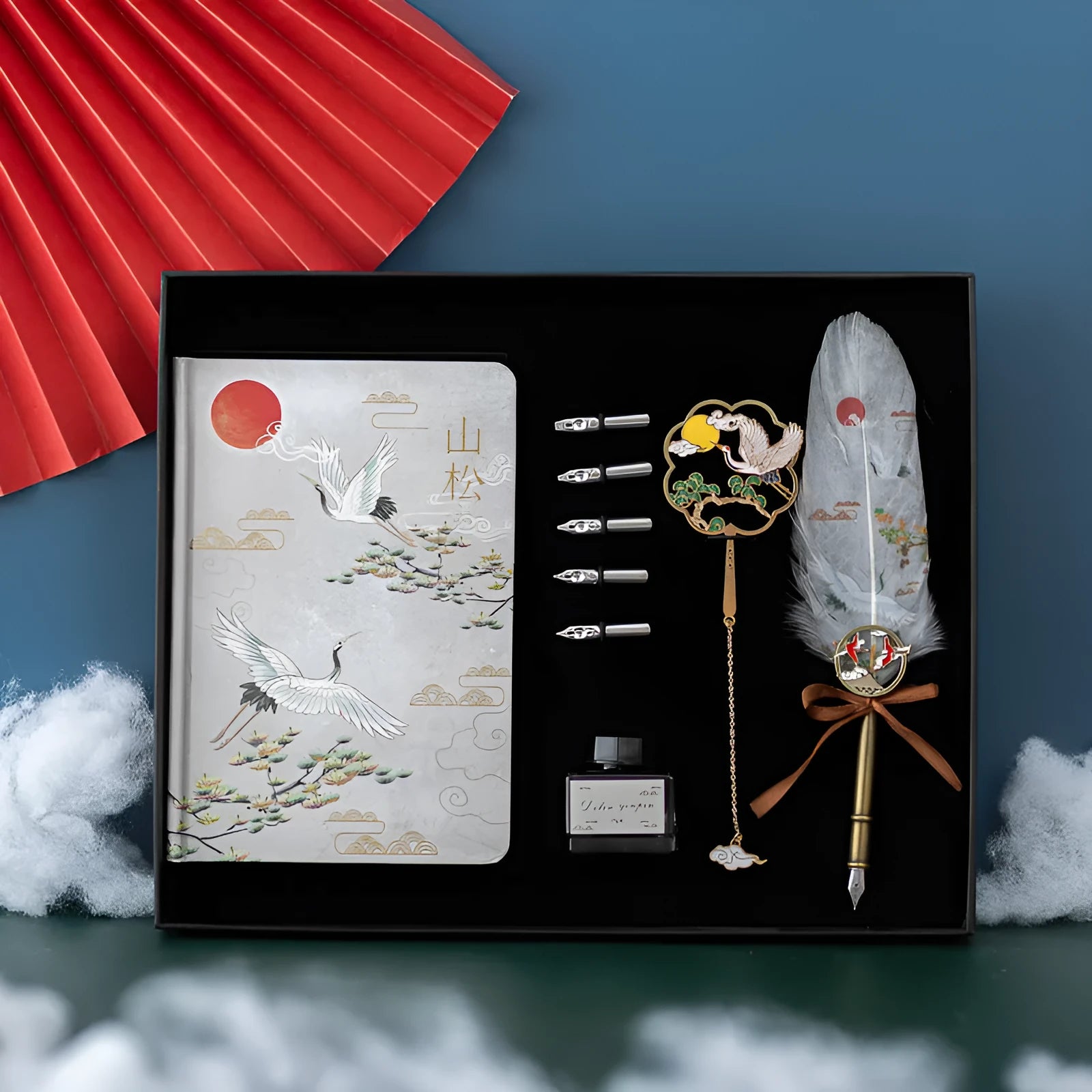 Chinese feather pen set with 36 quills in metal case and notebook.