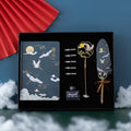 Chinese feather pen set with 36 quills in metal case and notebook.