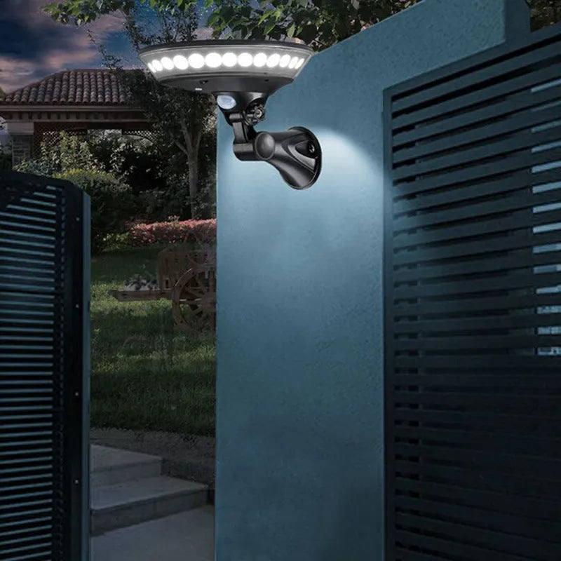 A 360-degree white solar-powered outdoor light with a motion sensor, shown in outdoor setting.