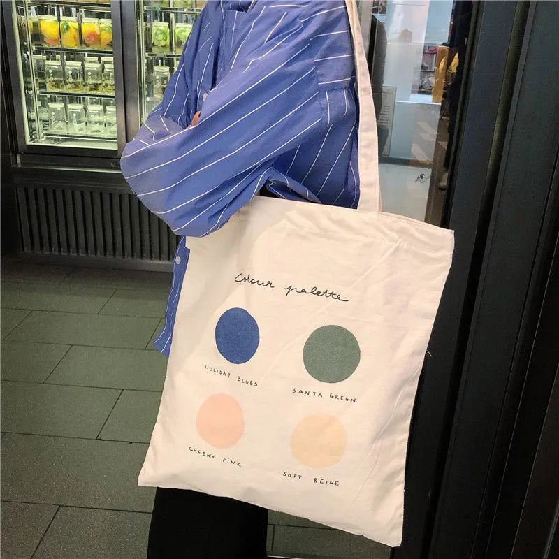 Women's medium canvas tote bag with geometric print, zipper closure, and soft handles in light pink colour
