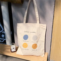 Women's medium canvas tote bag with geometric print, zipper closure, and soft handles in light pink colour