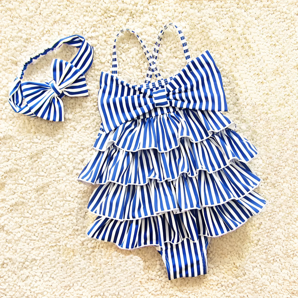 Navy style infant one-piece swimsuit with built-in steel support, pink colour with matching hair band, on a light background