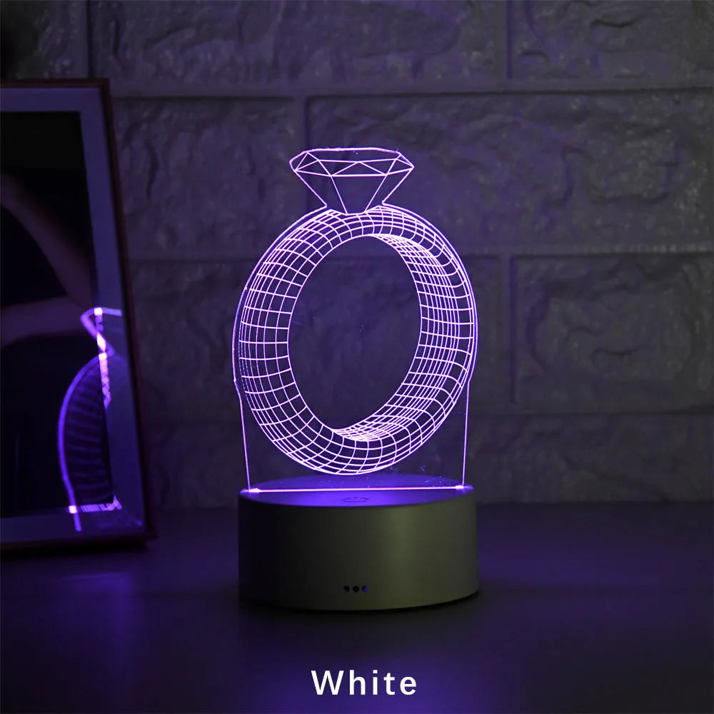 3D LED night light showing illuminated diamond ring design on a black background with colour-changing lights.