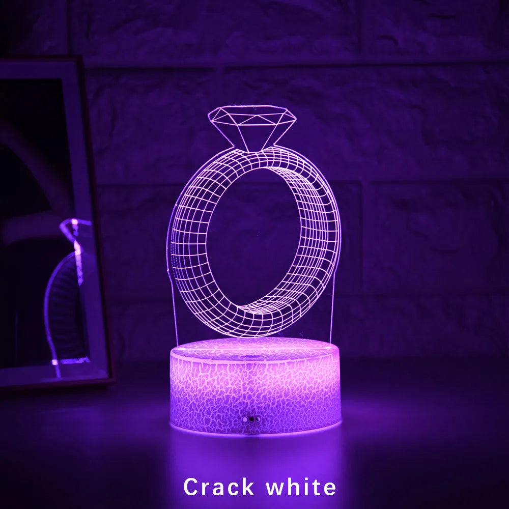 3D LED night light showing illuminated diamond ring design on a black background with colour-changing lights.