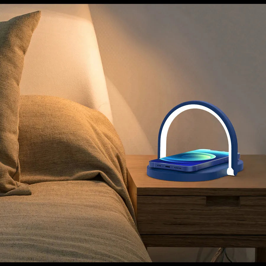 Black 15W wireless charger night light with phone holder on a wooden desk