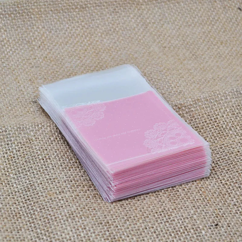 Pink plastic self-adhesive packaging bags for handmade soap and snacks, showing the adhesive seal.
