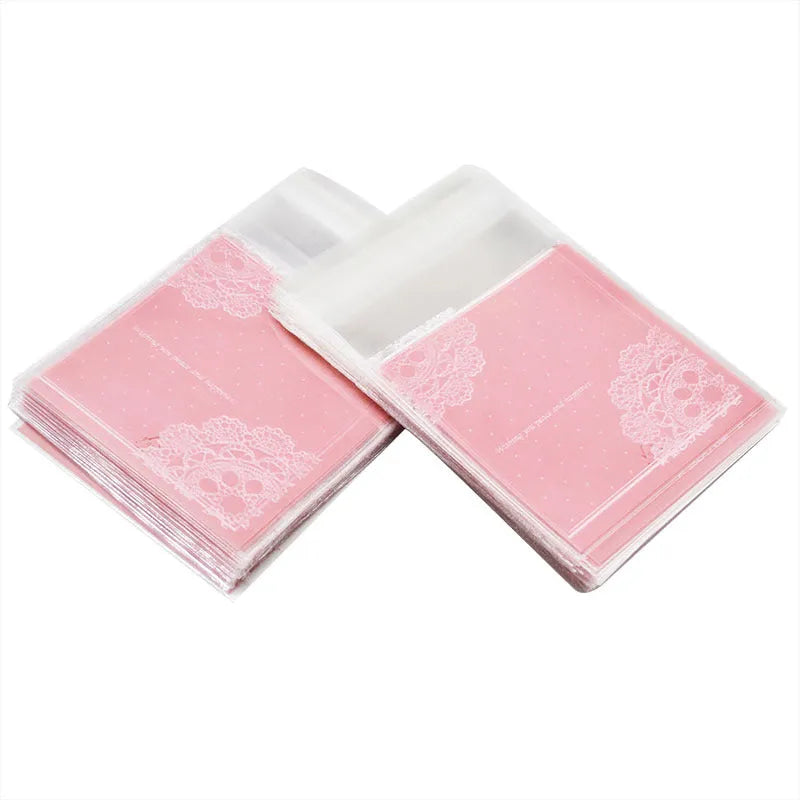 Pink plastic self-adhesive packaging bags for handmade soap and snacks, showing the adhesive seal.