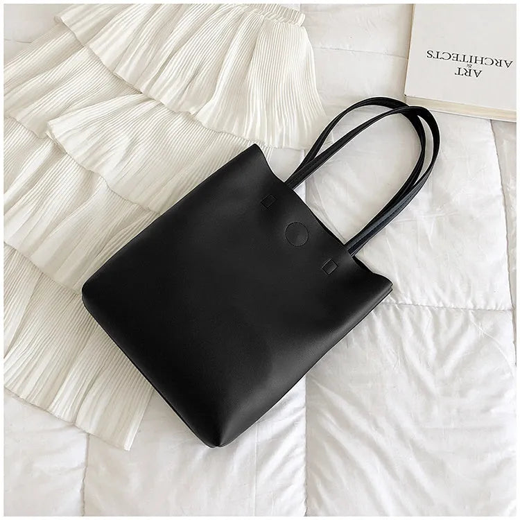 Large-capacity portable tote bag in Black with plain car suture design, soft handle, and single shoulder strap