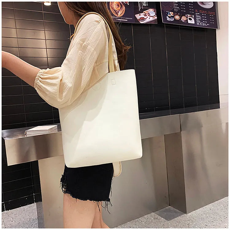 Large-capacity portable tote bag in Black with plain car suture design, soft handle, and single shoulder strap