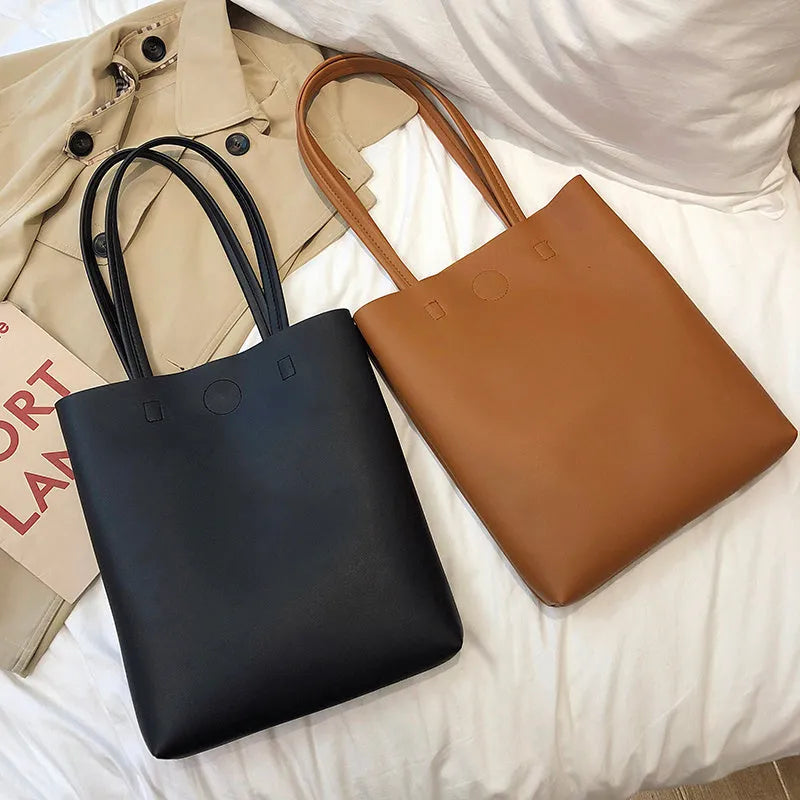 Large-capacity portable tote bag in Black with plain car suture design, soft handle, and single shoulder strap