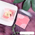 Pink plastic self-adhesive packaging bags for handmade soap and snacks, showing the adhesive seal.