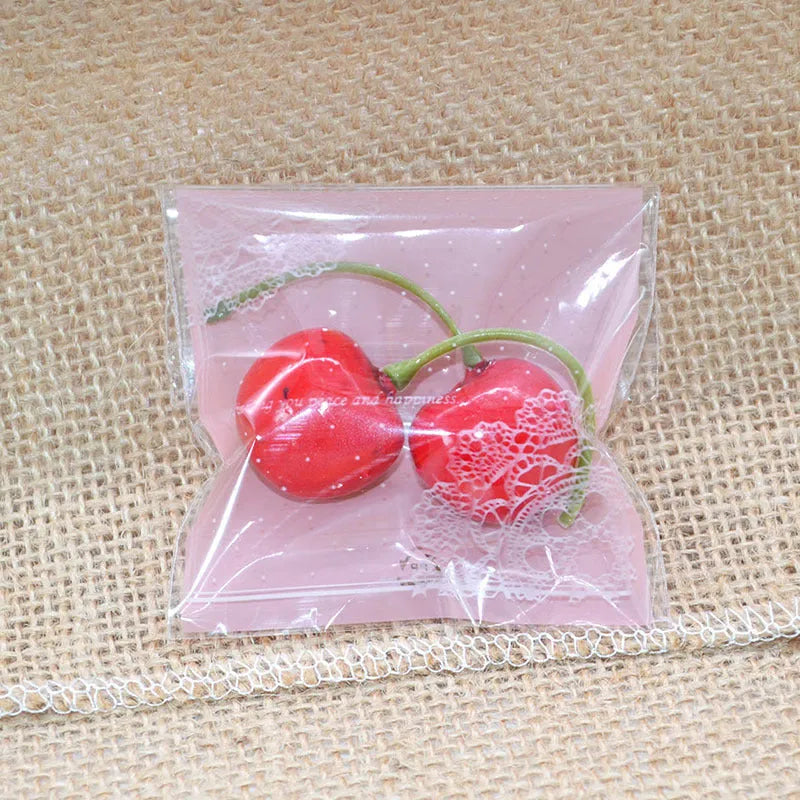 Pink plastic self-adhesive packaging bags for handmade soap and snacks, showing the adhesive seal.