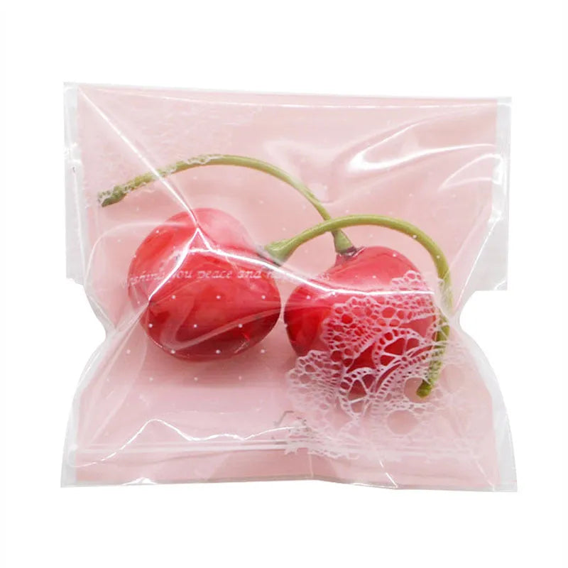 Pink plastic self-adhesive packaging bags for handmade soap and snacks, showing the adhesive seal.