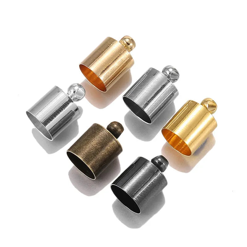 Assorted copper caps for jewellery making in gold, silver, bronze and black finishes, showing size variation.