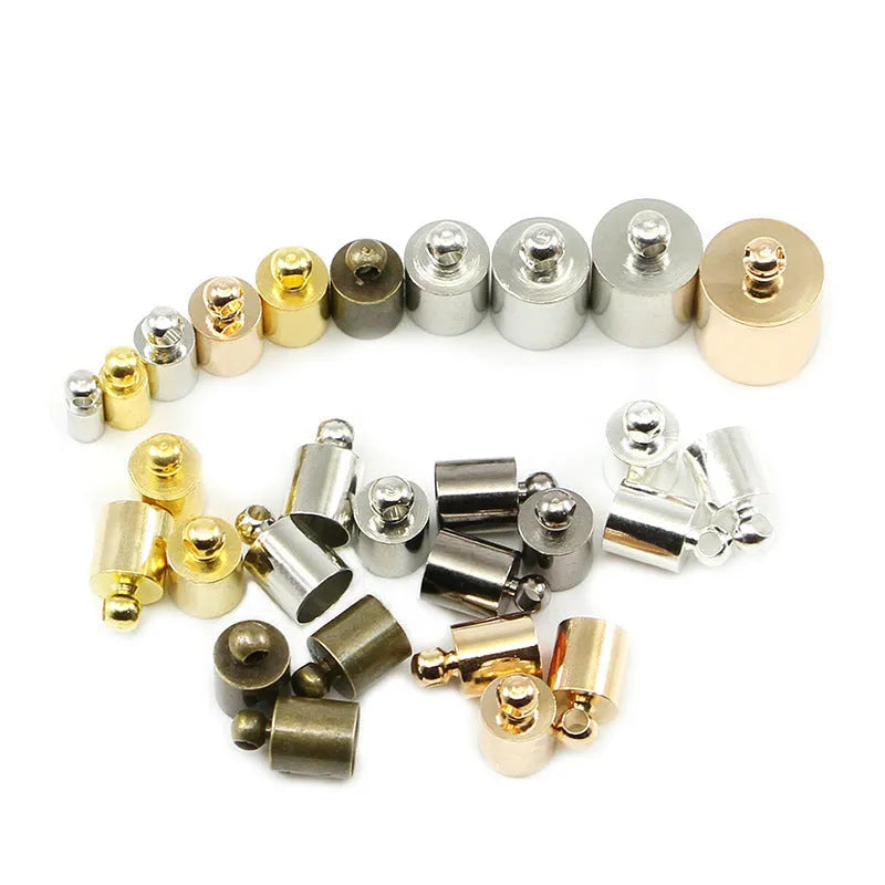 Assorted copper caps for jewellery making in gold, silver, bronze and black finishes, showing size variation.