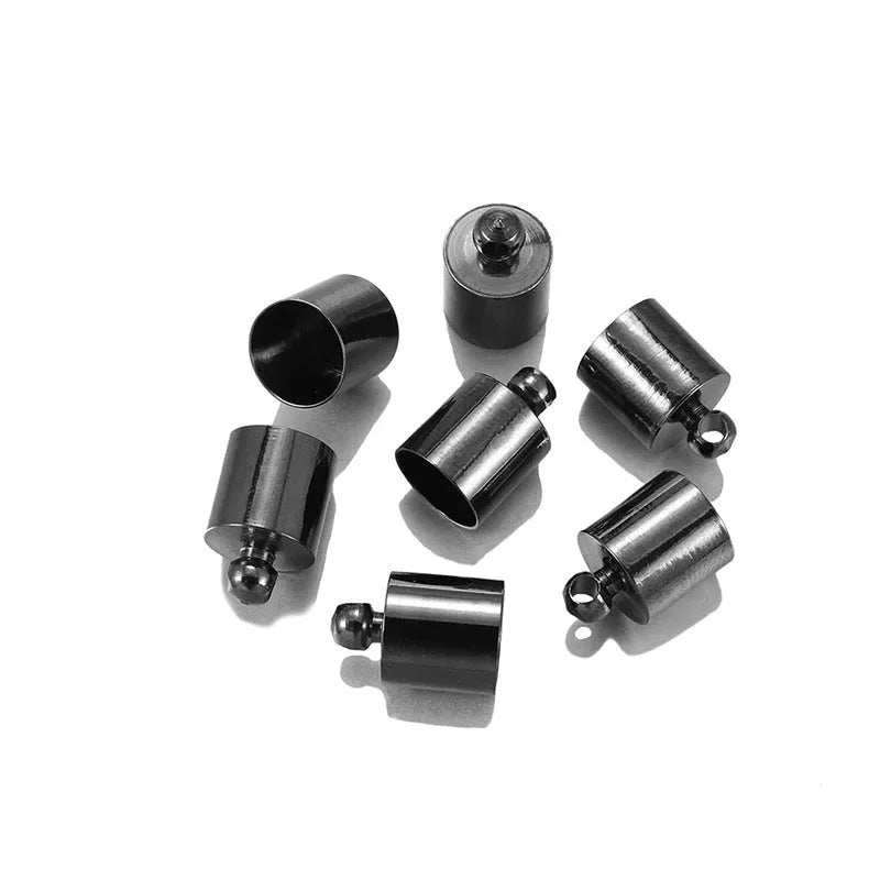 Assorted copper caps for jewellery making in gold, silver, bronze and black finishes, showing size variation.