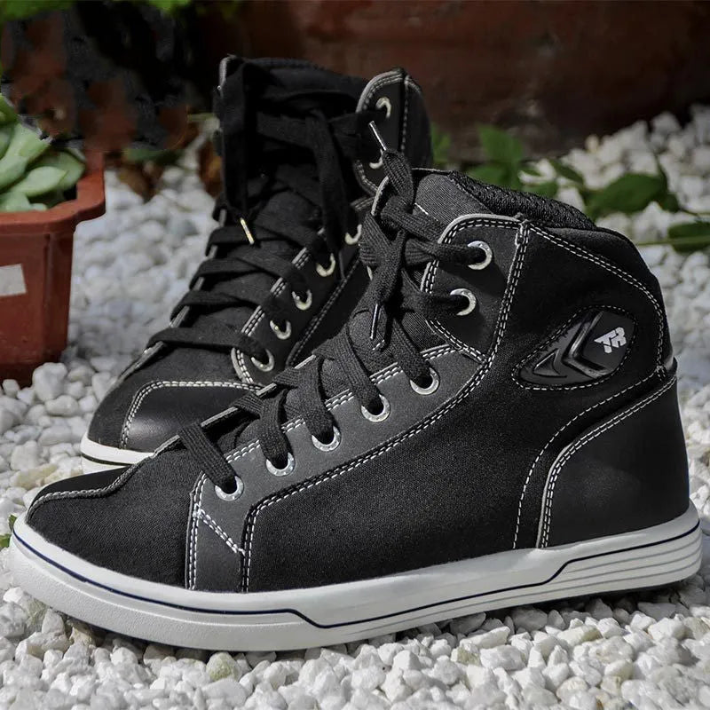 Black and grey men's summer motorcycle casual short boots on a plain background.