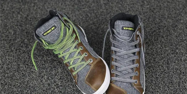 Black and grey men's summer motorcycle casual short boots on a plain background.