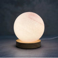 Nordic style USB-powered bedside table lamp with a glass shade, shown in one of seven available colours.