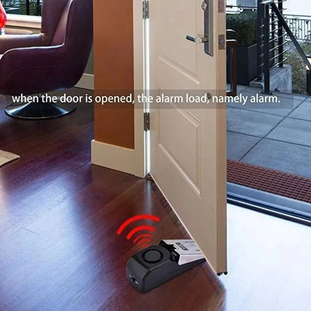 Electronic burglar alarm wedge door stop with ABS housing and 150dB siren on white background