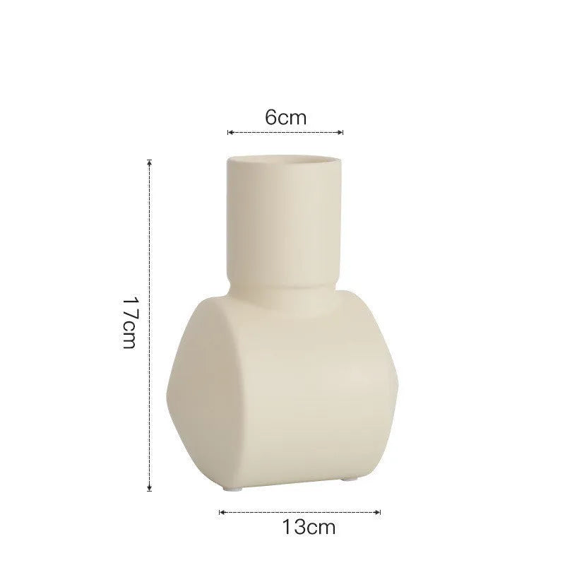 Nordic style Morandi ceramic vase with colour glaze in beige, brown, or purple on a wooden surface.