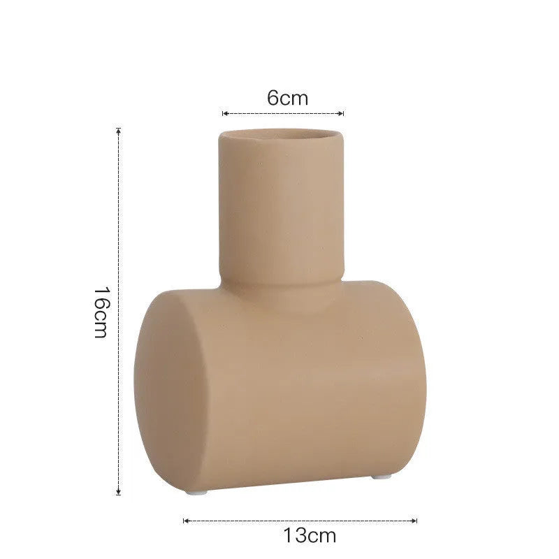 Nordic style Morandi ceramic vase with colour glaze in beige, brown, or purple on a wooden surface.