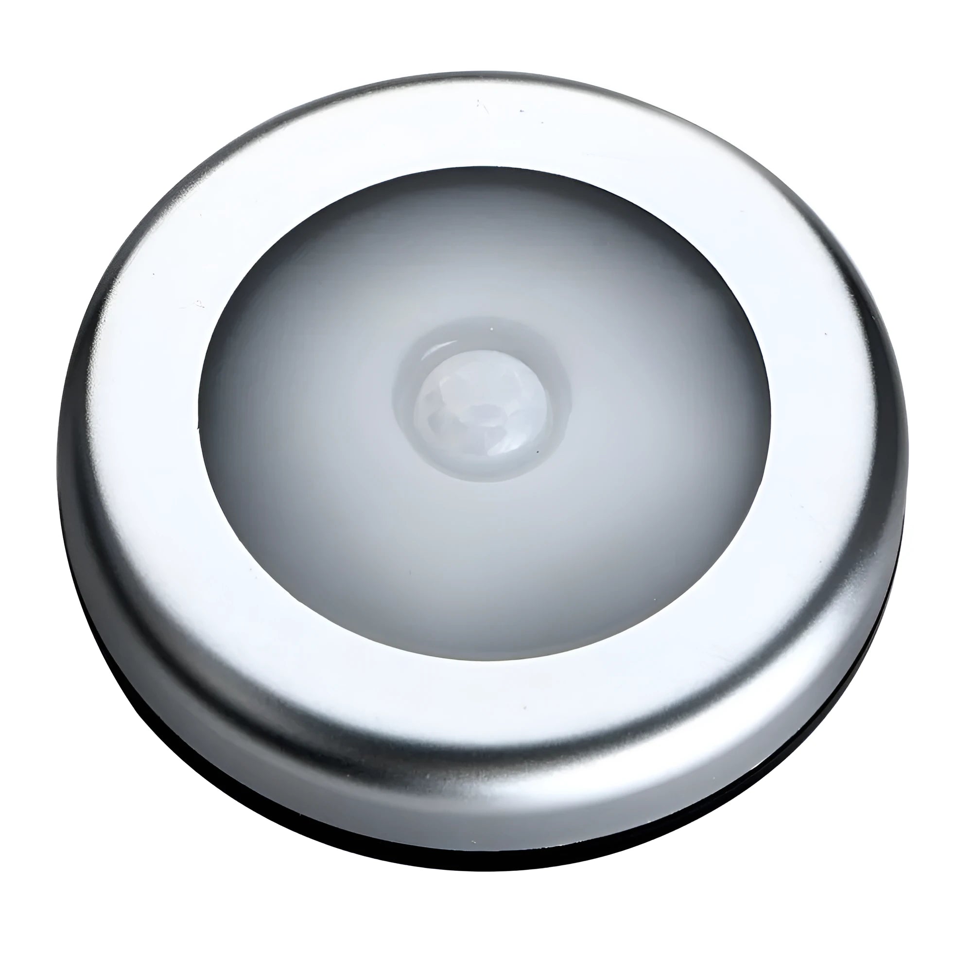 Silver circular battery-powered motion sensor night light on a surface.