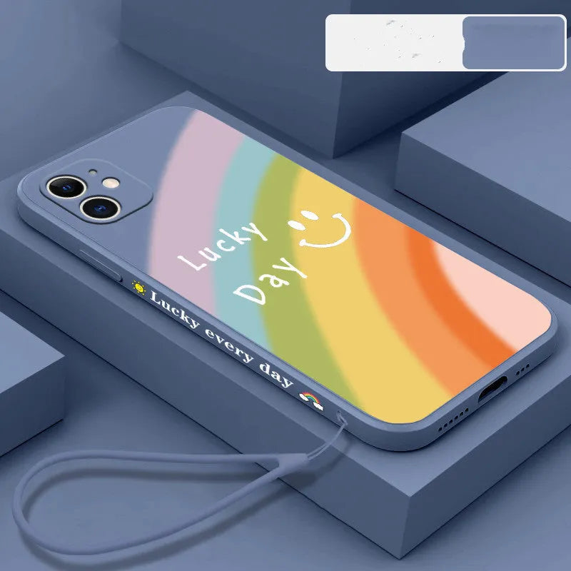 Rainbow smiley face design on a colourful silicone phone case for iPhone, showing blue, green, purple, and red colour options.