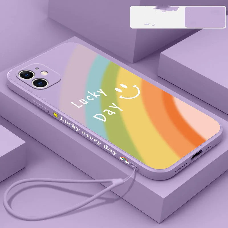 Rainbow smiley face design on a colourful silicone phone case for iPhone, showing blue, green, purple, and red colour options.