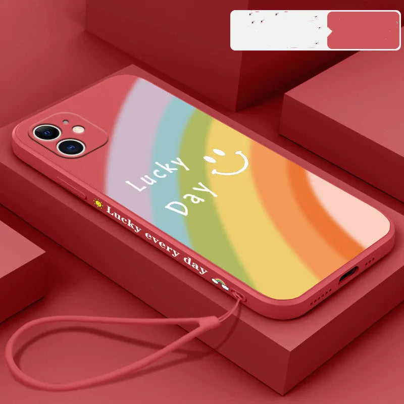 Rainbow smiley face design on a colourful silicone phone case for iPhone, showing blue, green, purple, and red colour options.