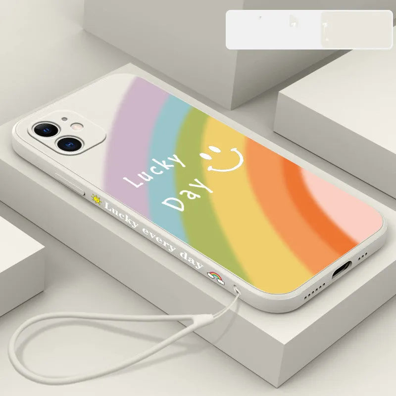 Rainbow smiley face design on a colourful silicone phone case for iPhone, showing blue, green, purple, and red colour options.