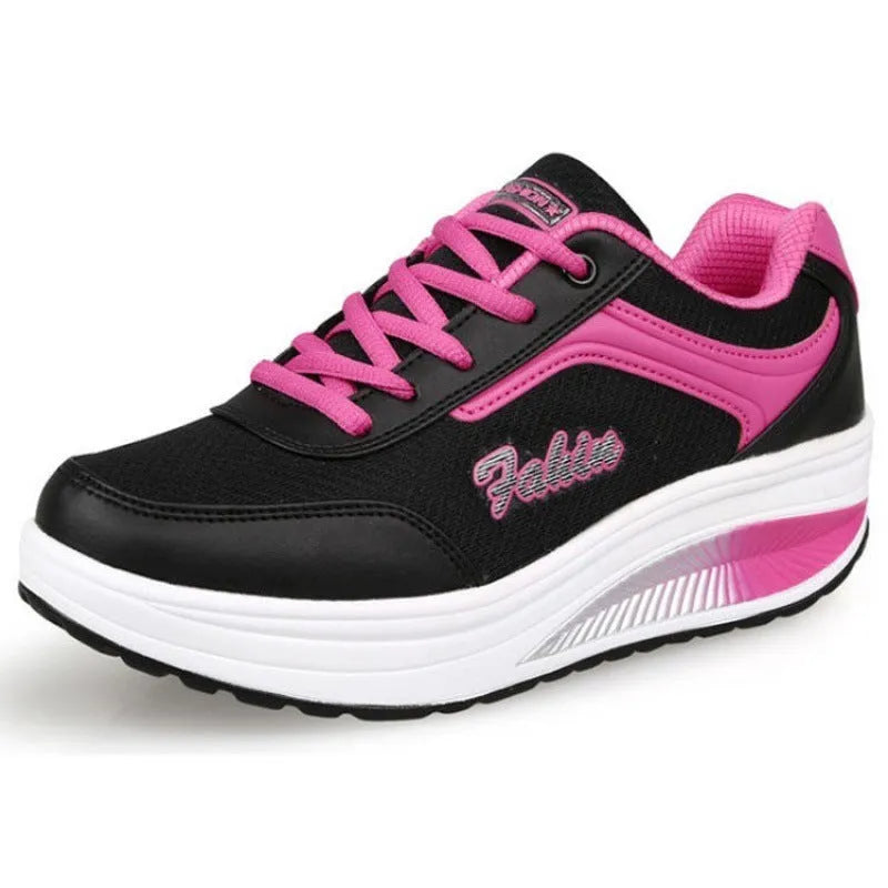 Women's grey powder heelless sports travel shoes with a mid heel on a plain background
