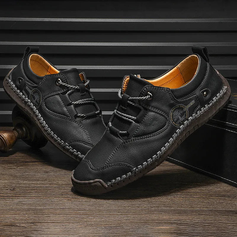 Men's black casual leather shoes with microfiber upper and round toe on a plain background