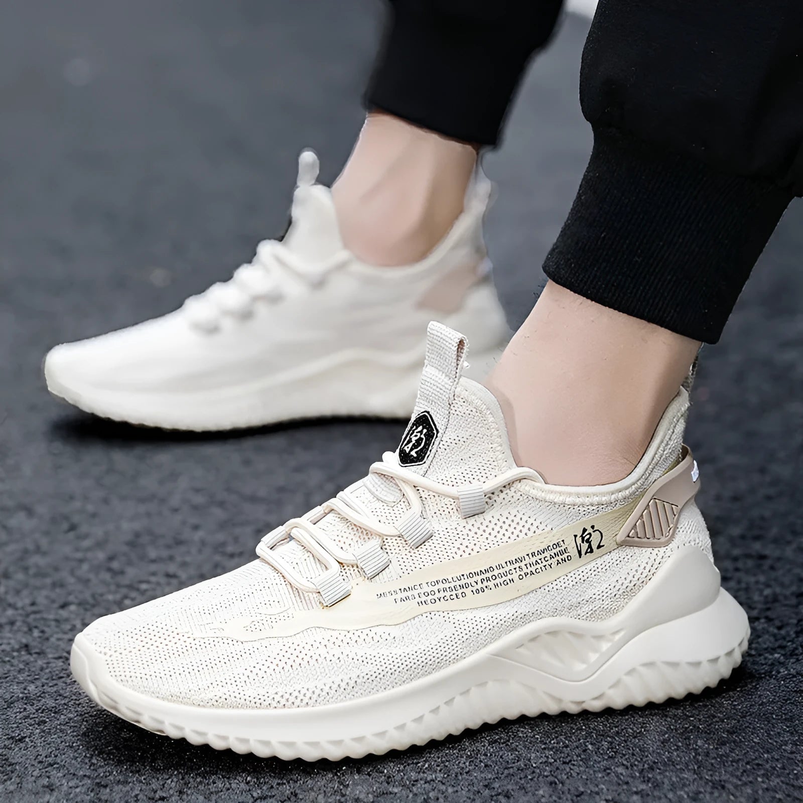 Men's white mesh sports shoes with rubber sole and low-cut design on neutral background